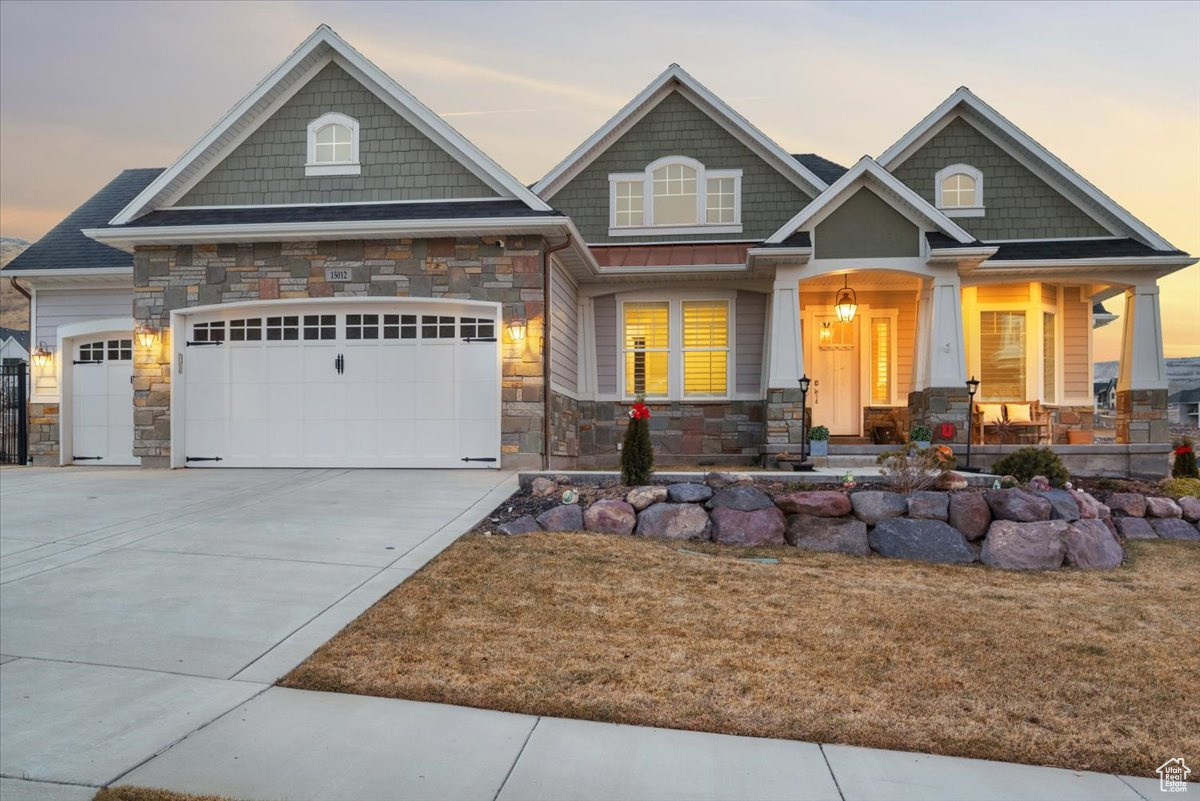 Craftsman house with a porch and a garage