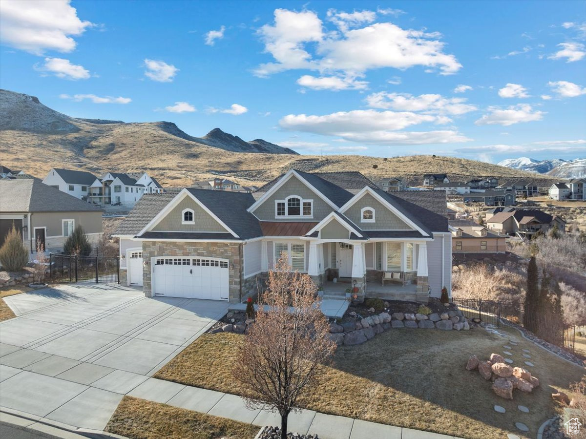 Craftsman inspired home with a mountain view, covered porch, and a garage