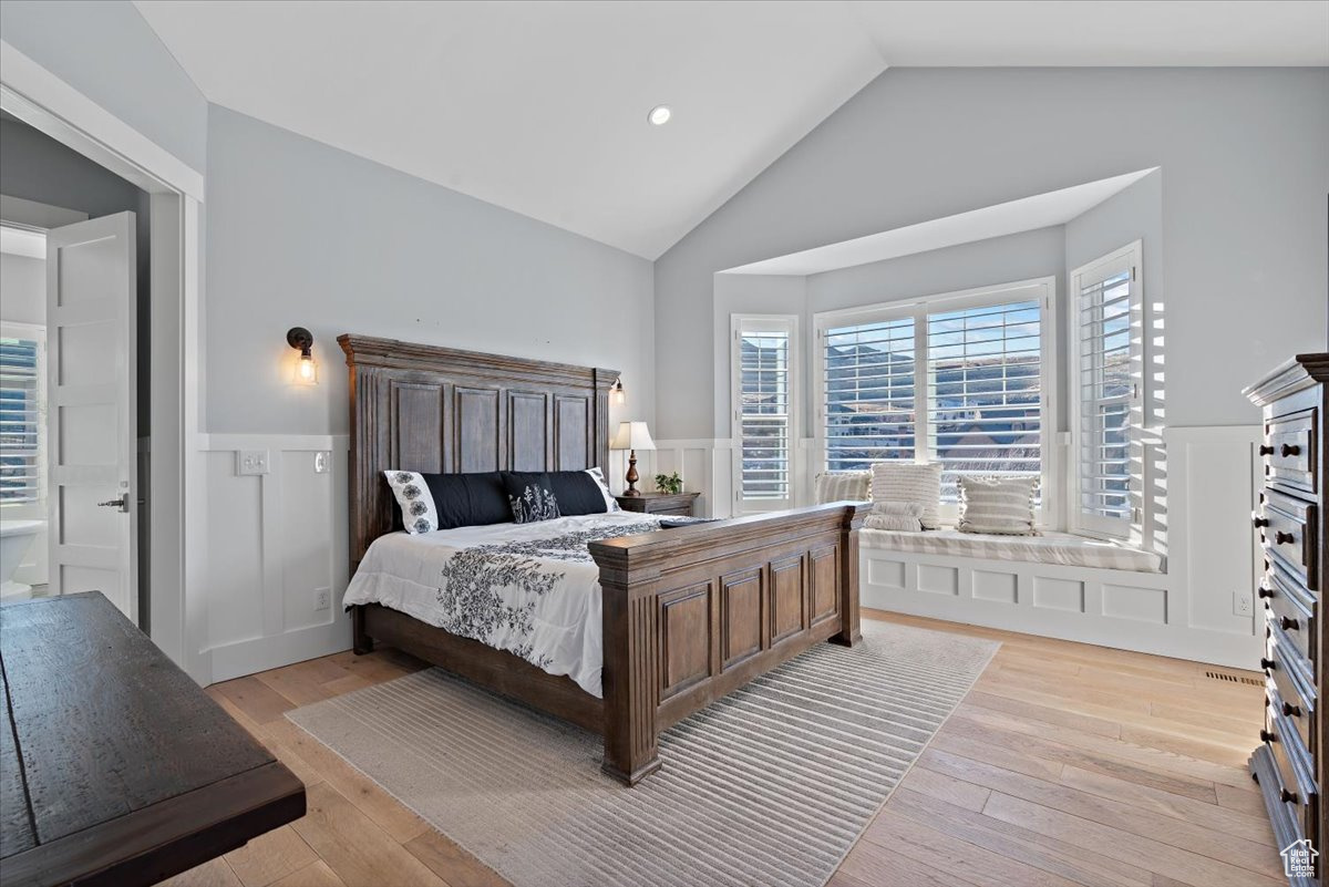 Bedroom featuring light hardwood / wood-style floors and vaulted ceiling