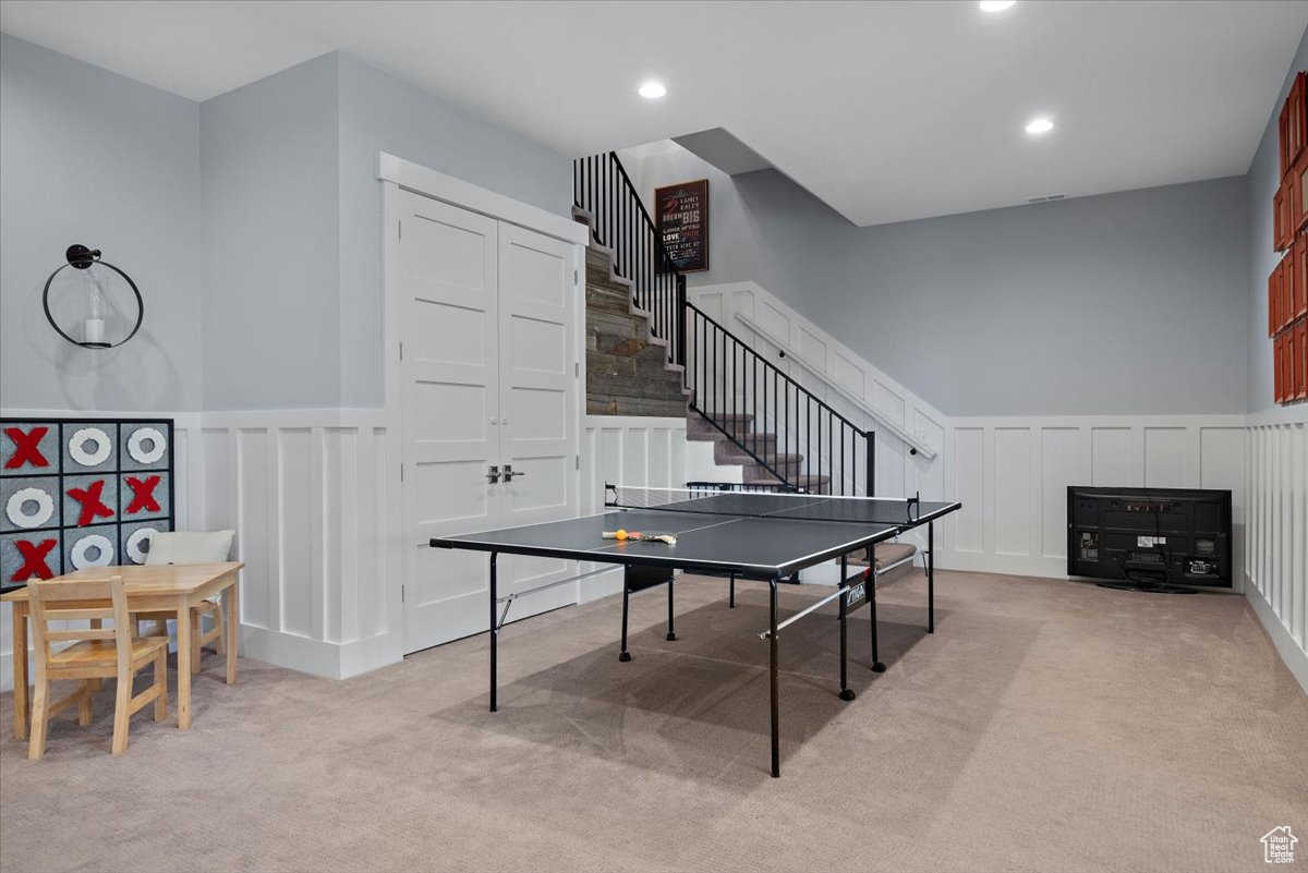 Game room featuring light carpet