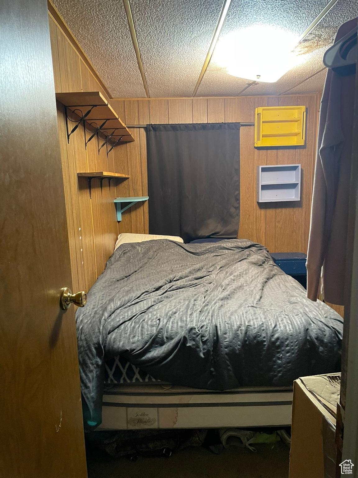 Bedroom featuring wooden walls