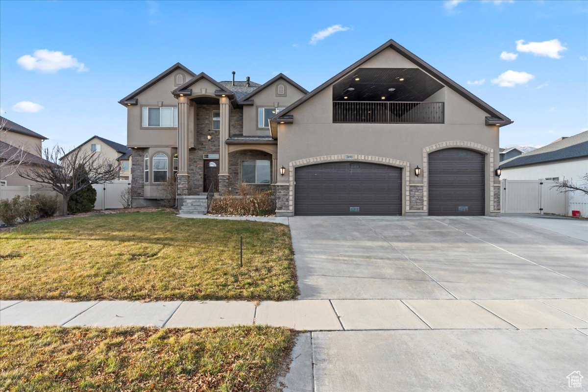 View of front of house with a front lawn and a garage