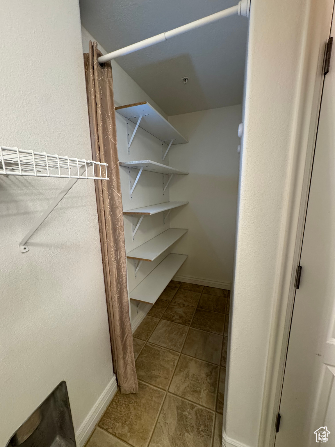 Walk in closet with tile patterned flooring