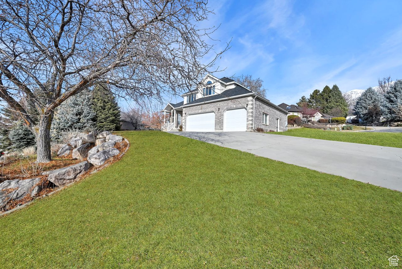 Exterior space featuring a front lawn and a garage