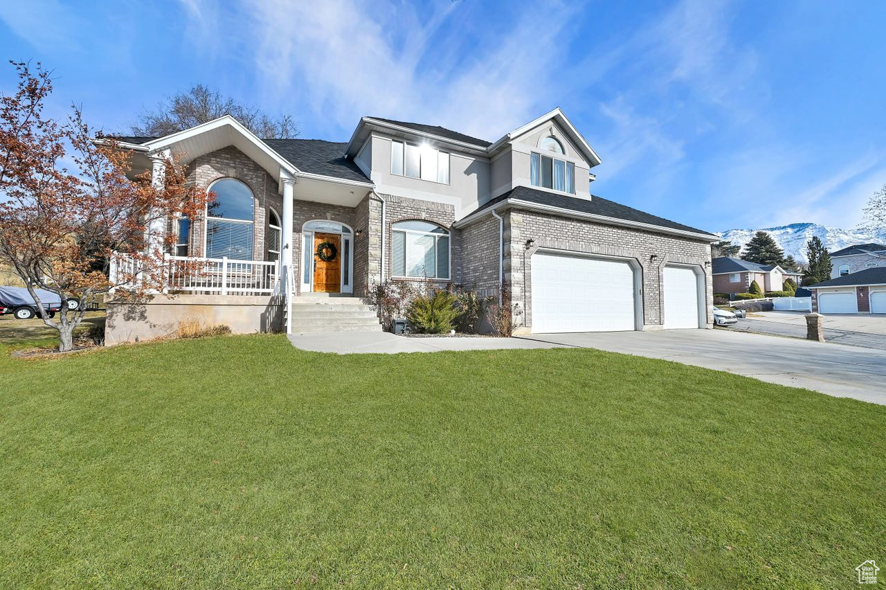 View of front of home with a garage and a front yard