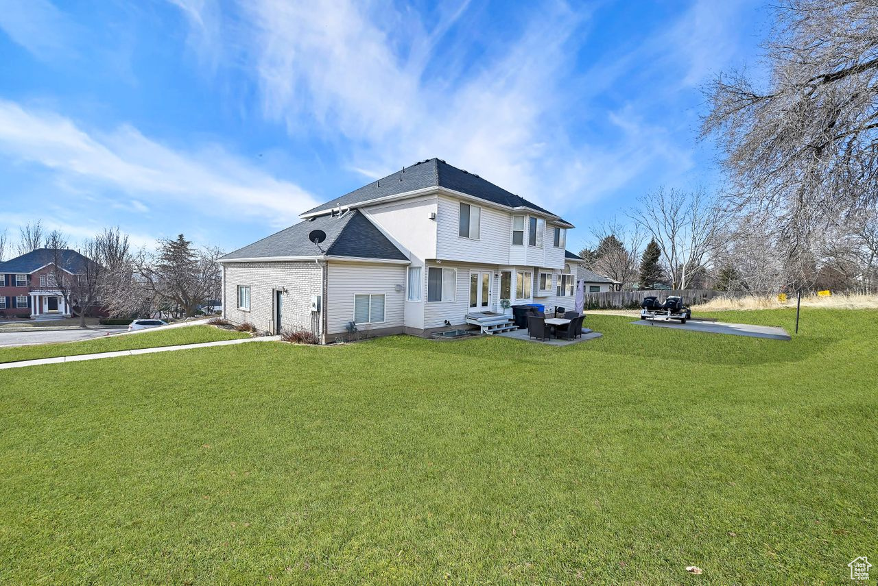 Back of house featuring a patio and a lawn