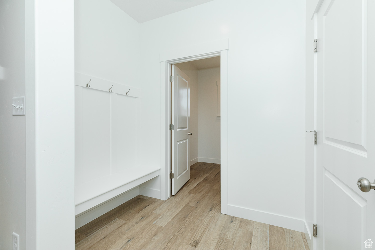 Hallway with light hardwood / wood-style flooring