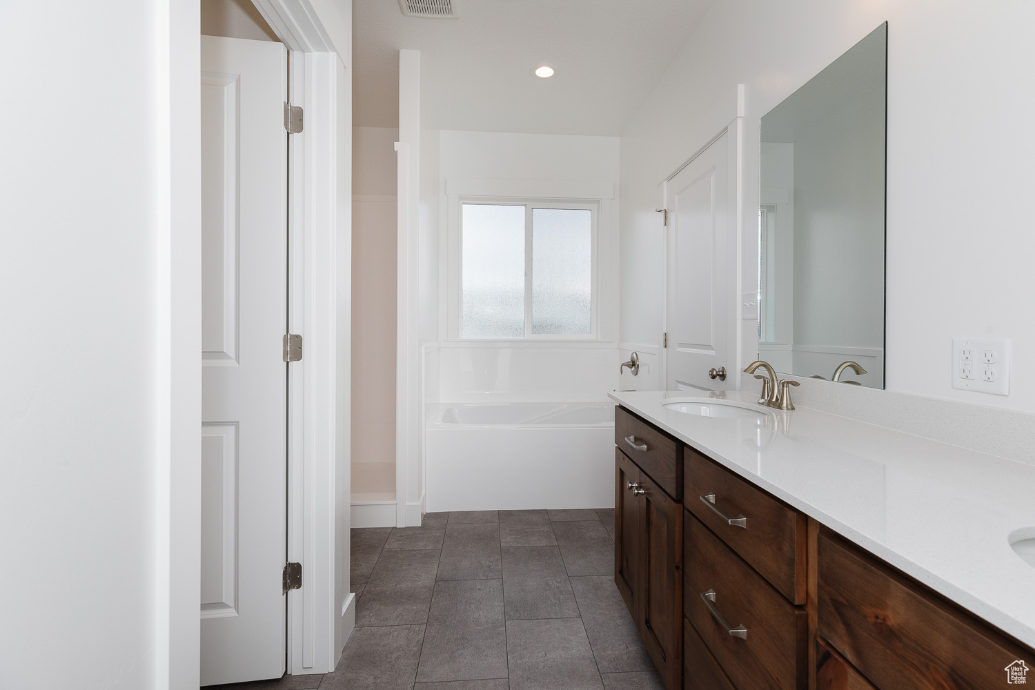 Bathroom with vanity and a bathing tub