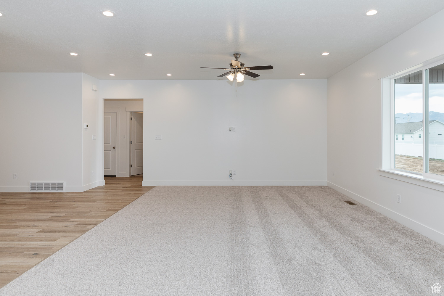 Spare room with ceiling fan and light wood-type flooring
