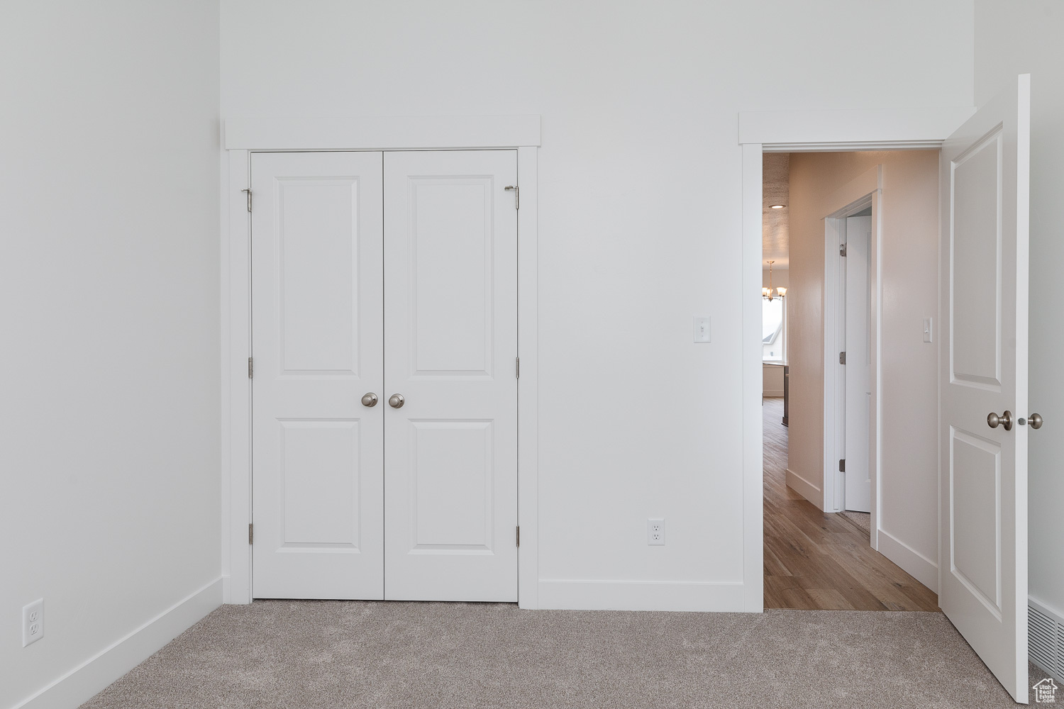 Unfurnished bedroom featuring light colored carpet and a closet