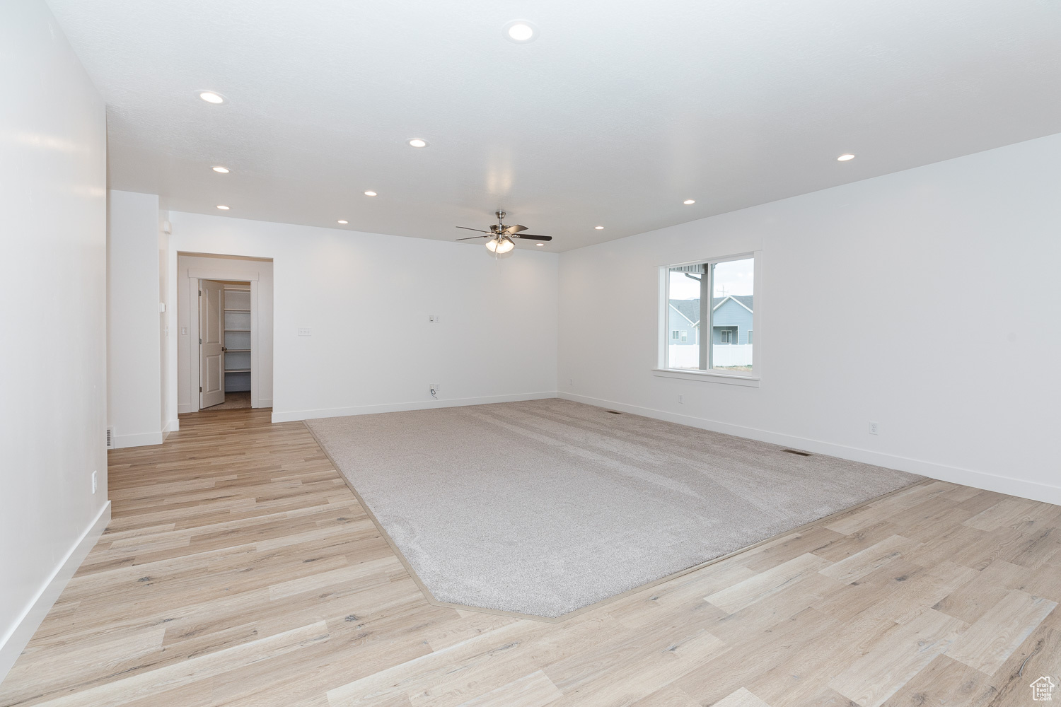 Spare room with light wood-type flooring and ceiling fan