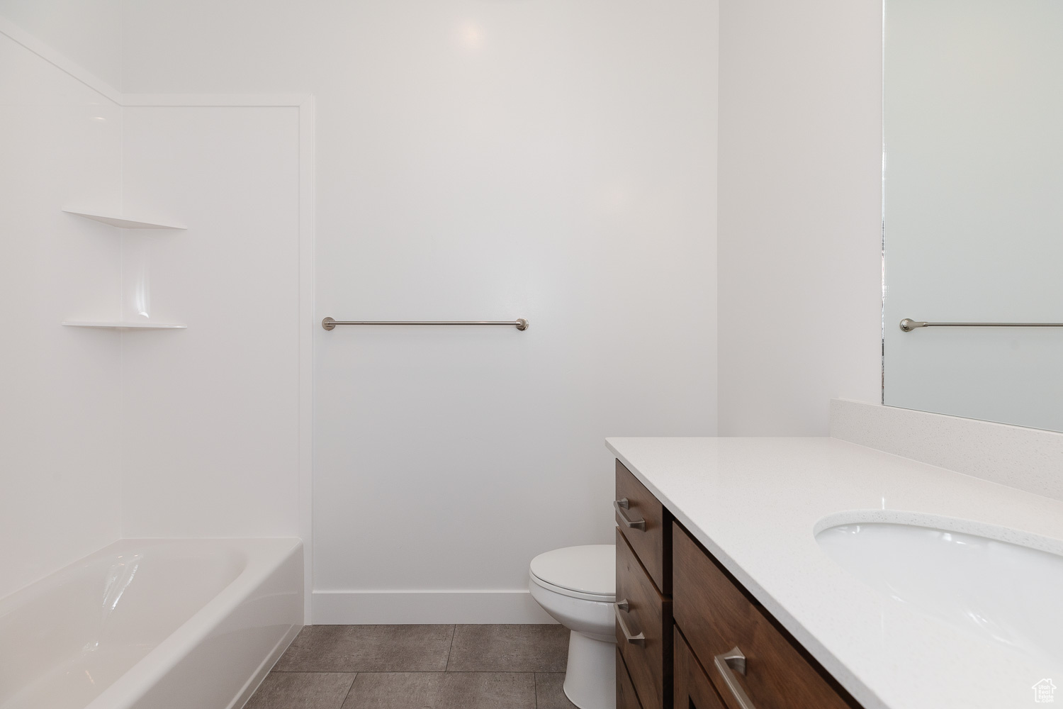 Bathroom with tile patterned flooring, vanity, and toilet