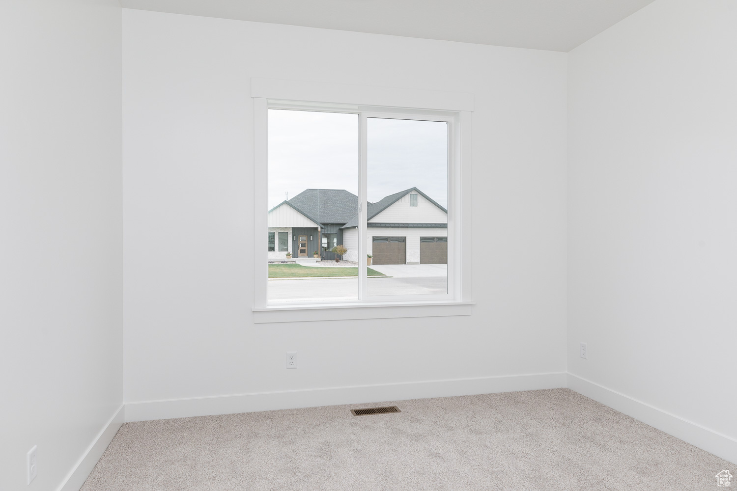 Carpeted spare room with a wealth of natural light