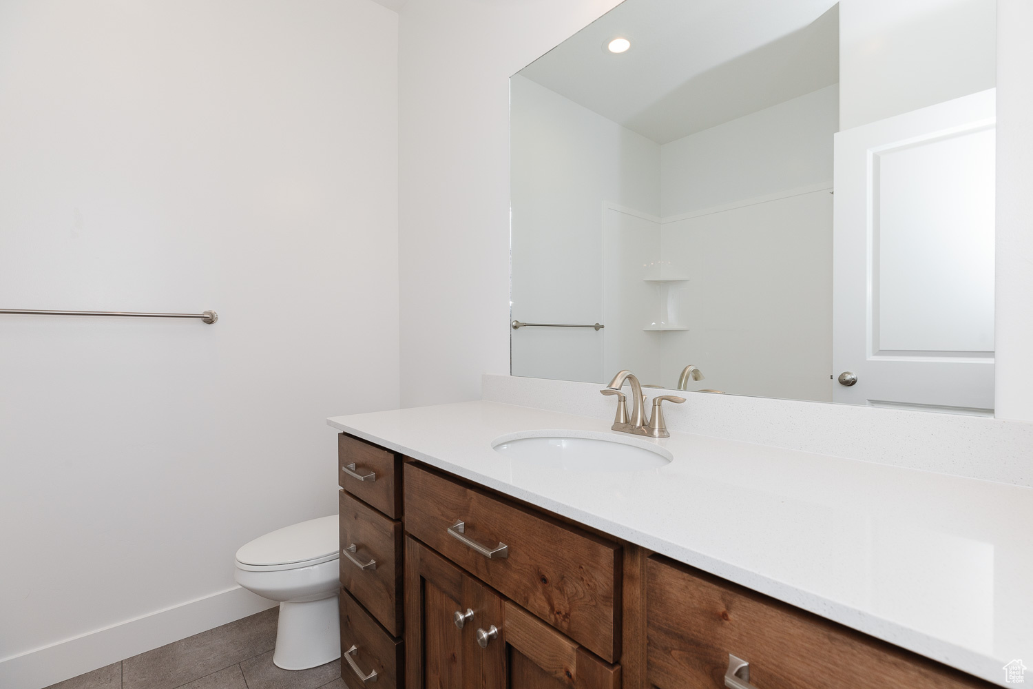 Bathroom with tile patterned floors, vanity, and toilet