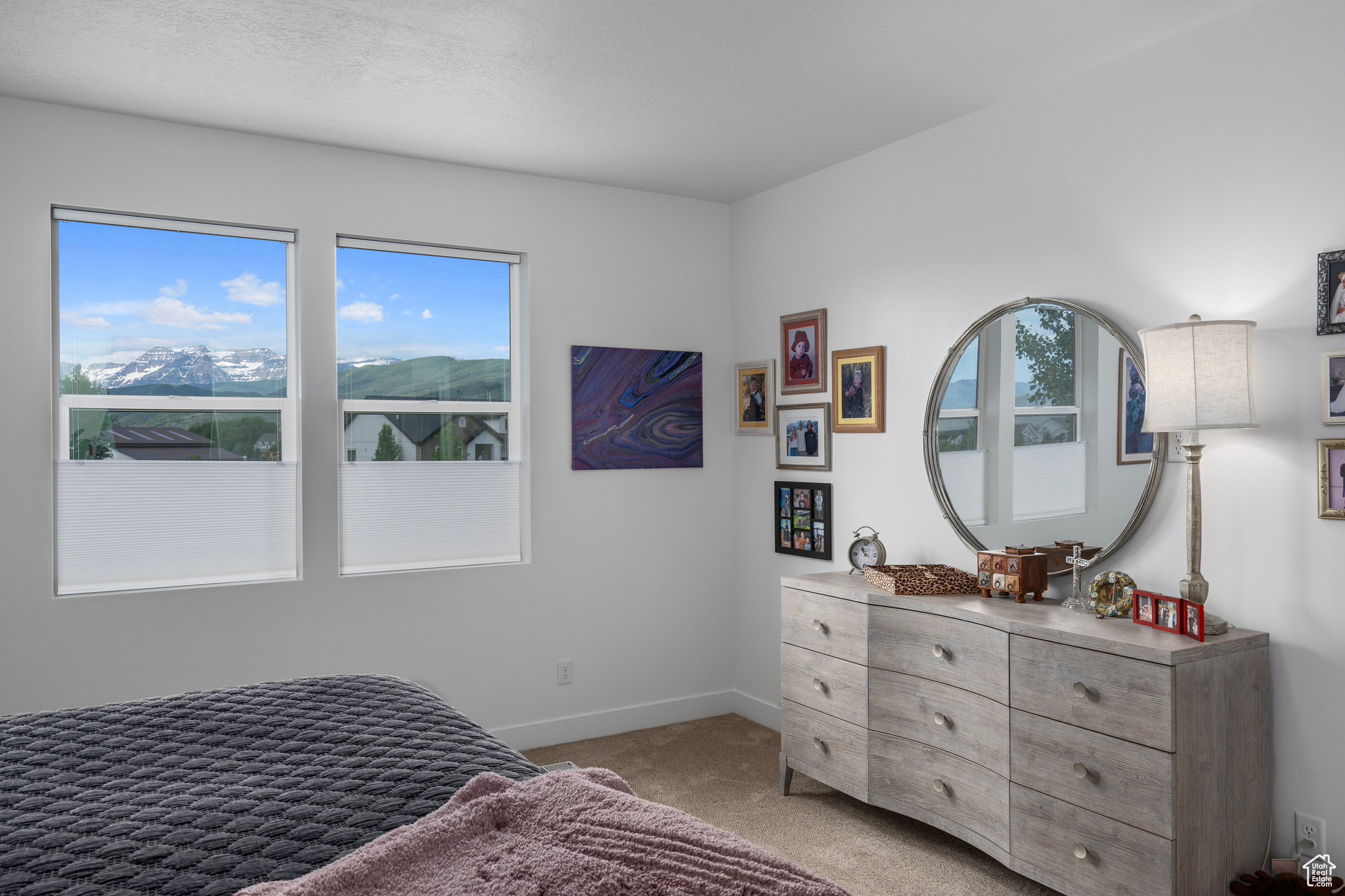 Bedroom featuring a mountain view and light colored carpet