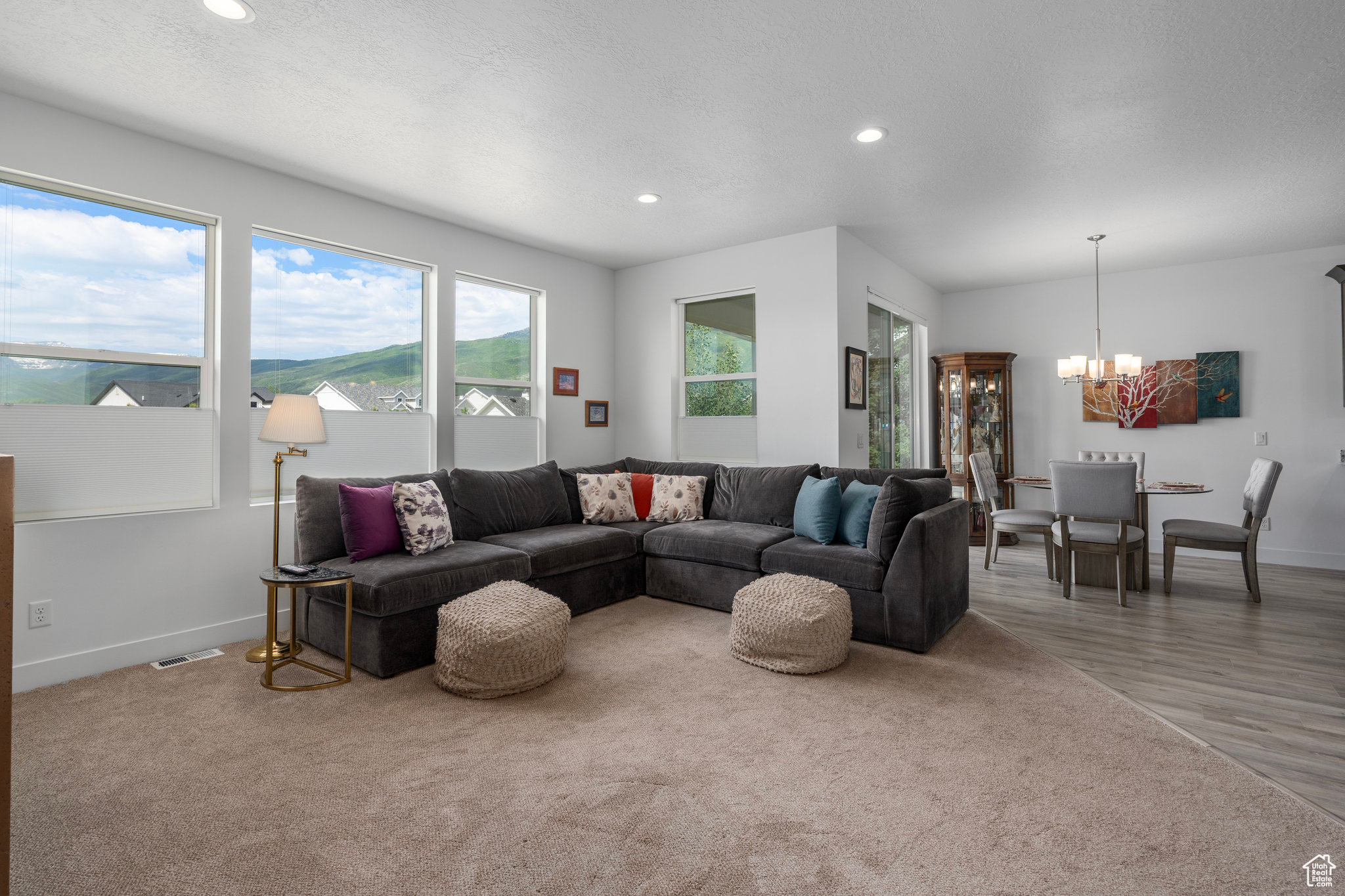 Living room with a mountain view, hardwood / wood-style floors, and a notable chandelier