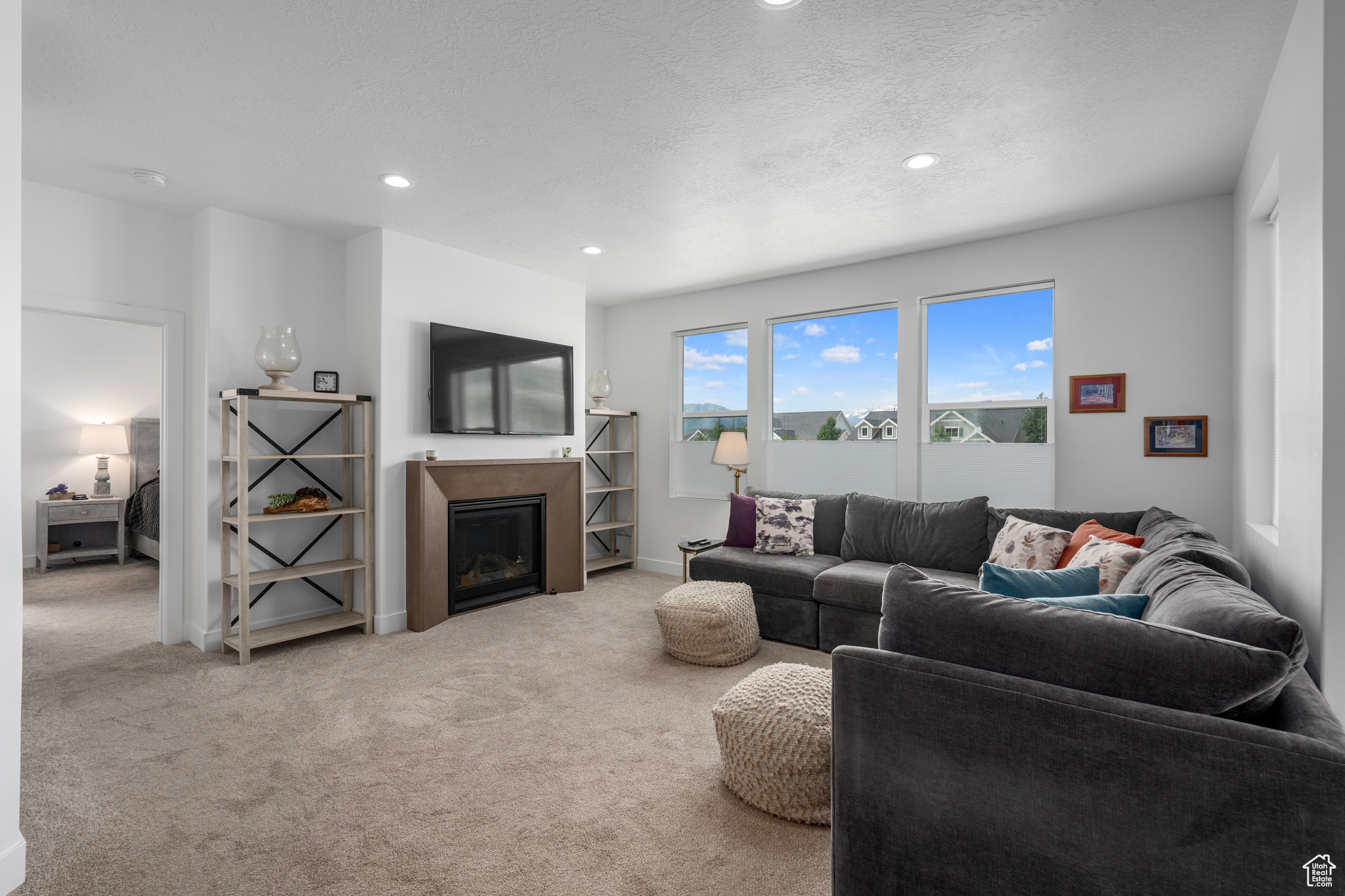 Carpeted living room featuring a textured ceiling