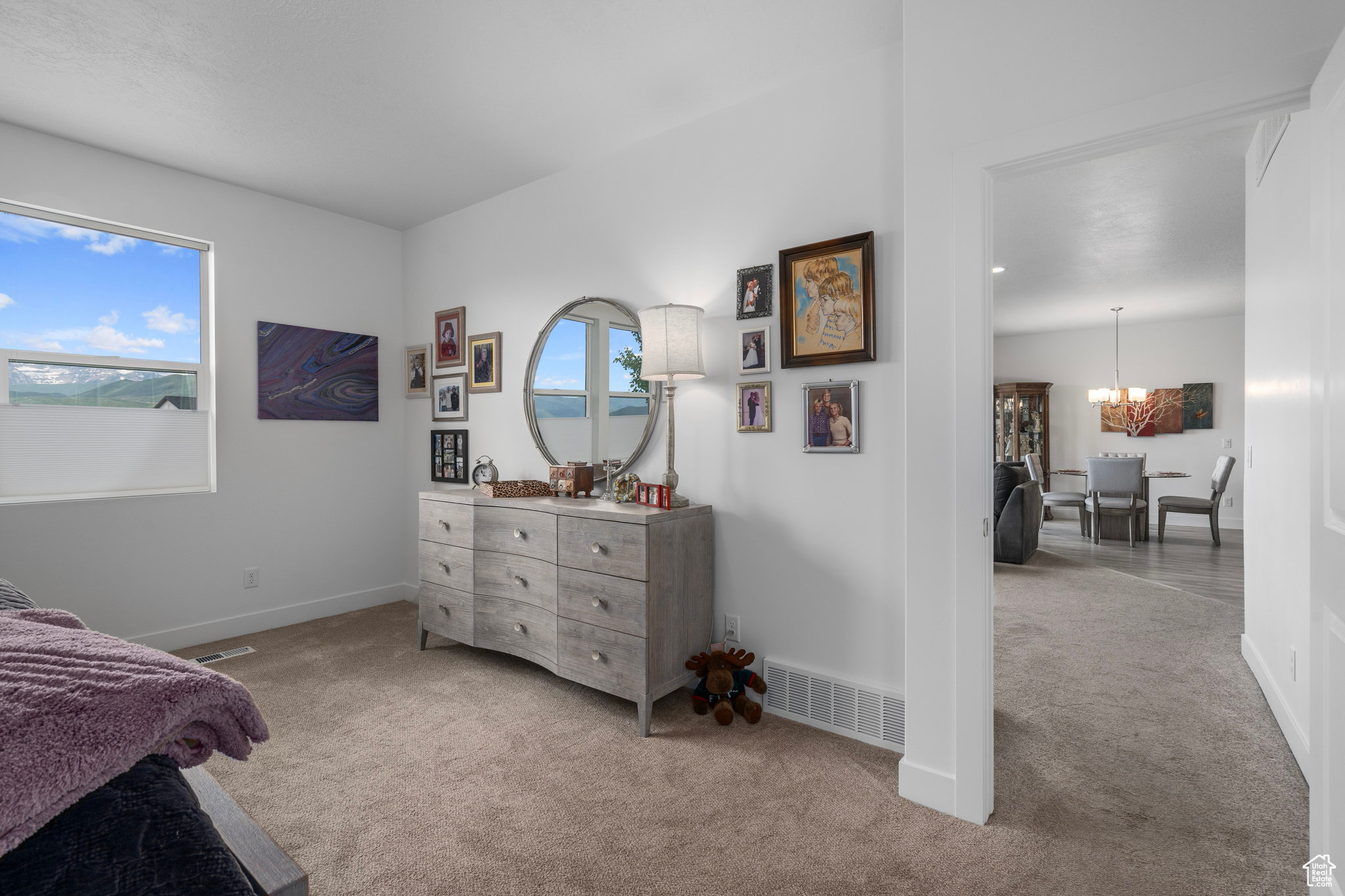 Carpeted bedroom with a notable chandelier