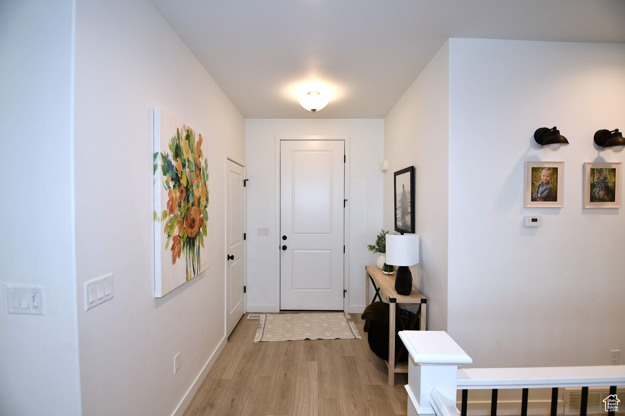 Foyer entrance with light hardwood / wood-style floors