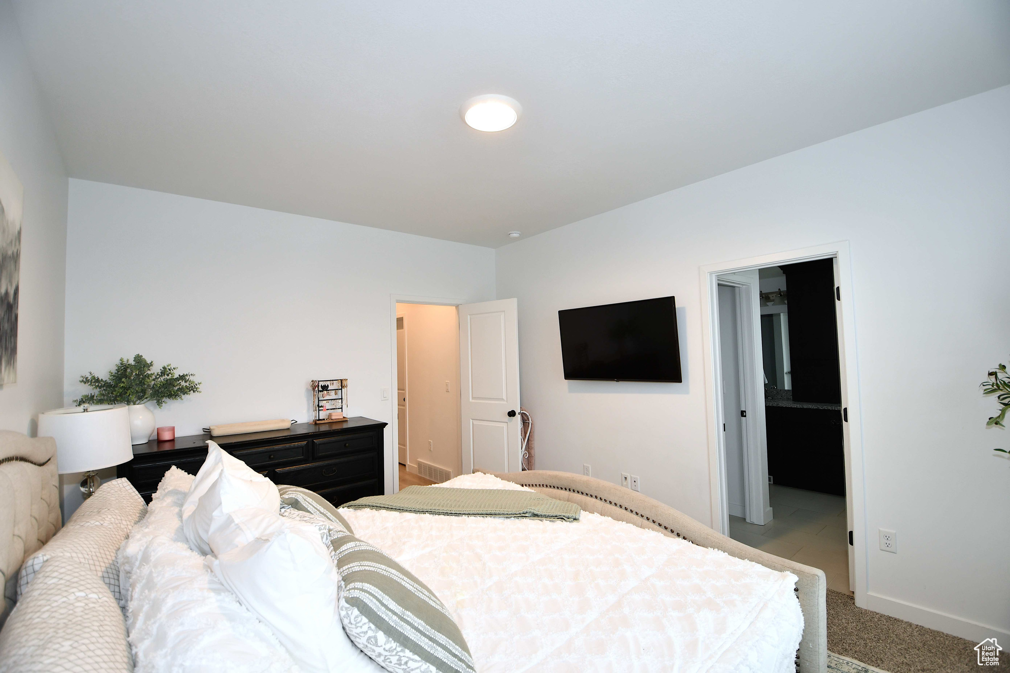 Bedroom featuring light colored carpet