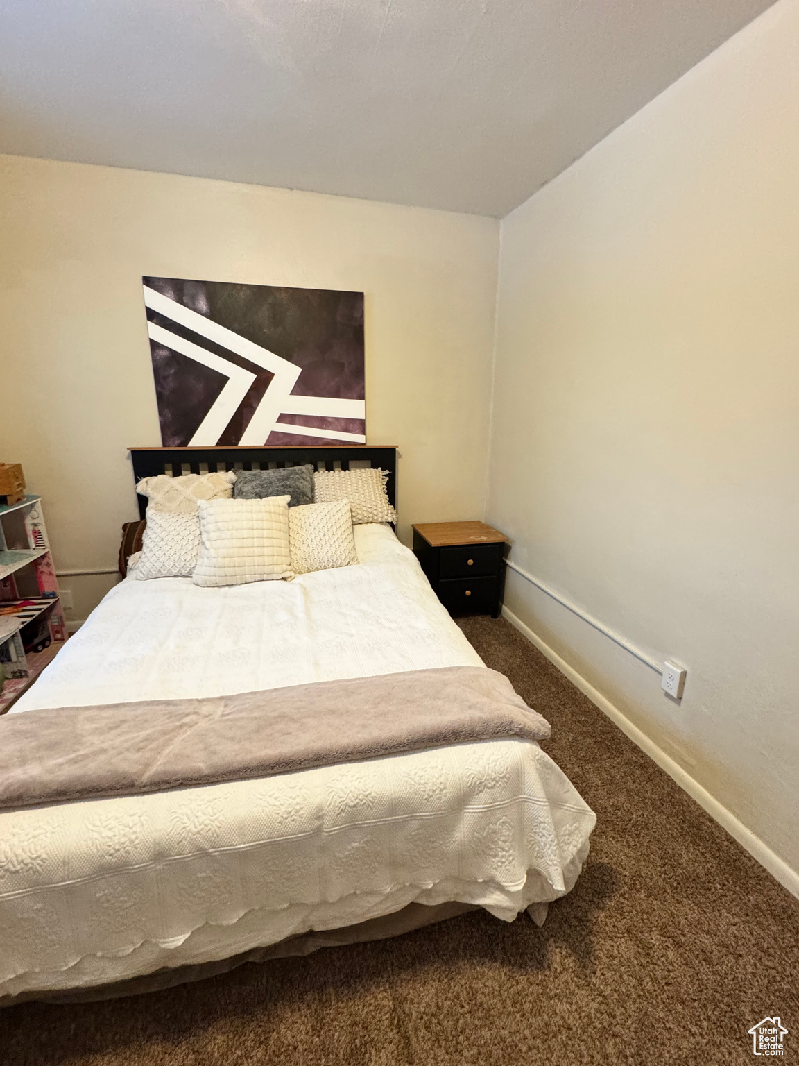 Bedroom featuring baseboards and carpet flooring