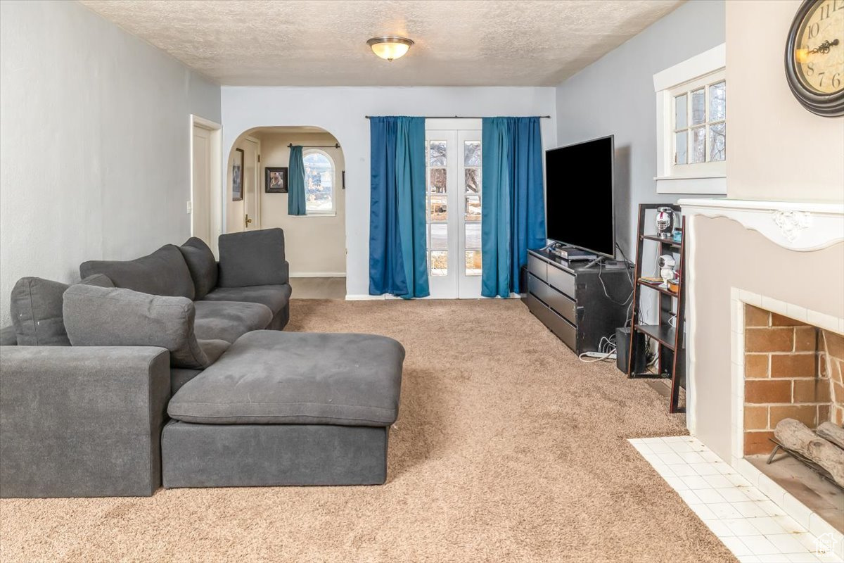 Carpeted living room featuring a textured ceiling