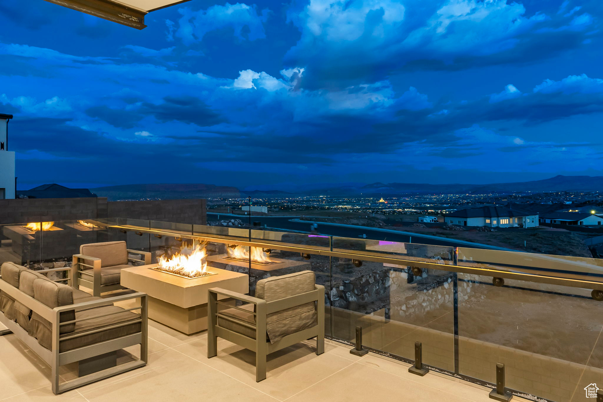 Balcony at dusk featuring a fire pit