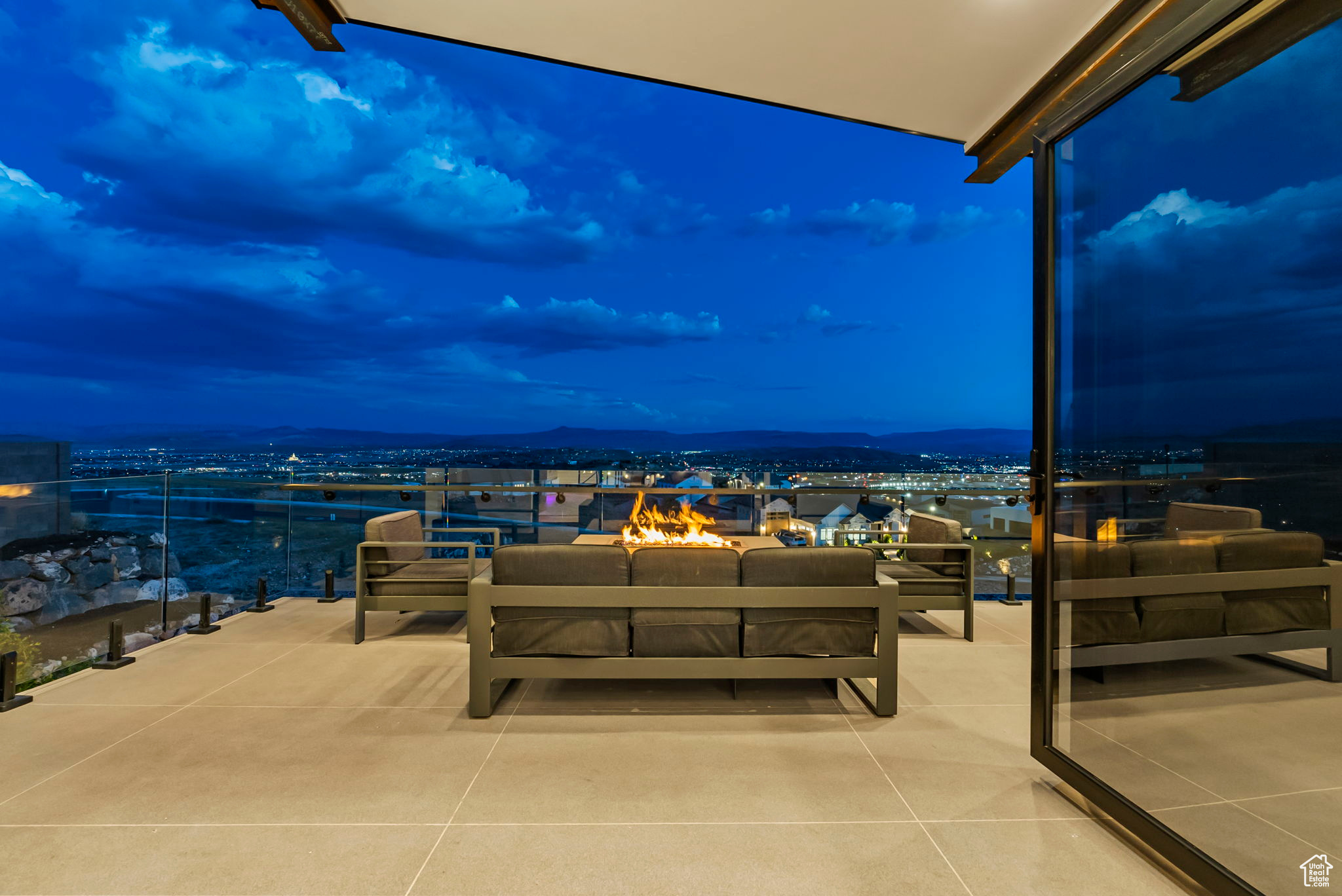 Patio terrace at dusk with a mountain view and an outdoor hangout area