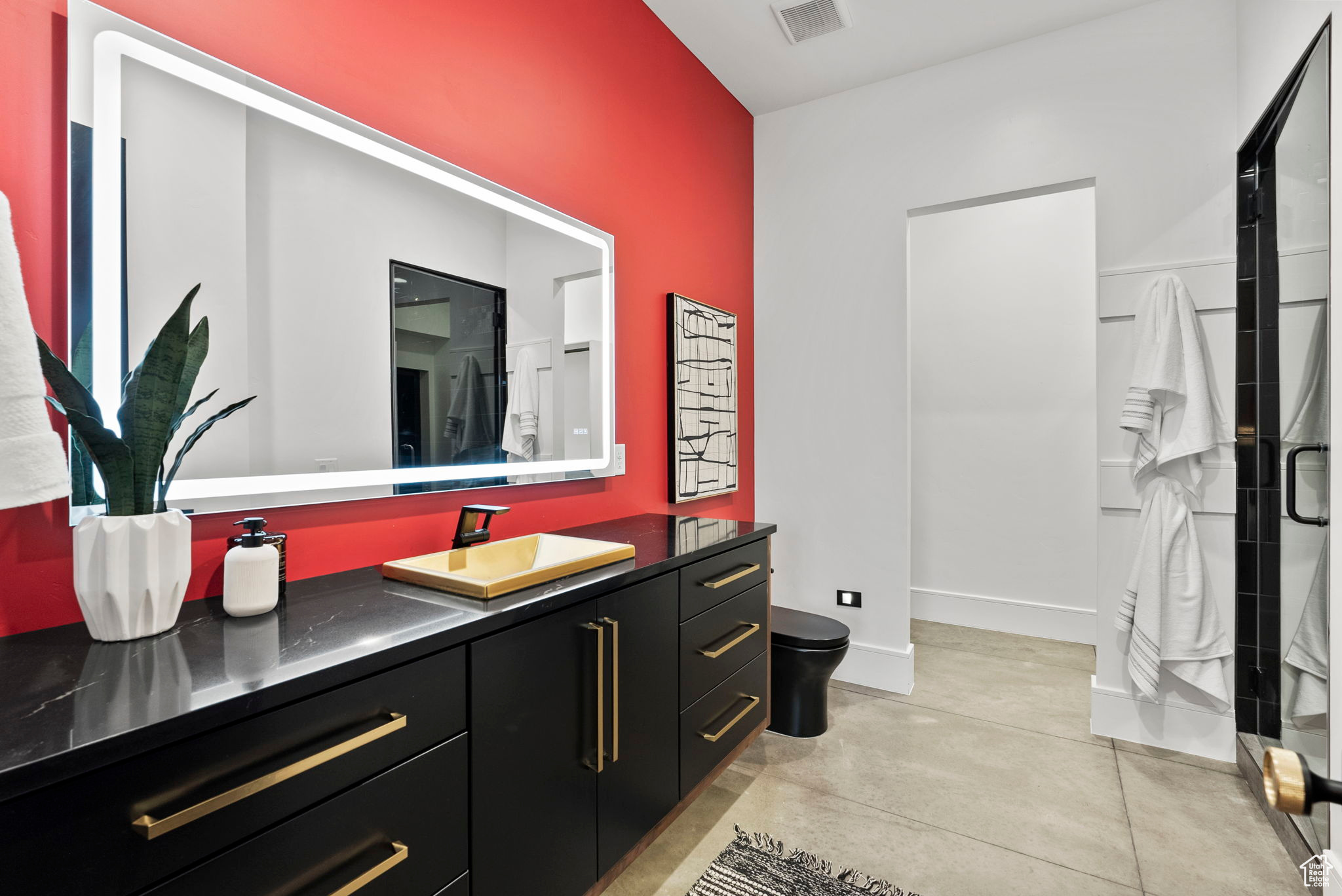 Bathroom with vanity, toilet, and an enclosed shower