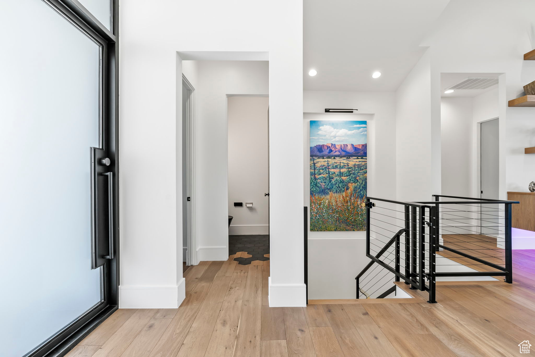 Hallway with light hardwood / wood-style flooring