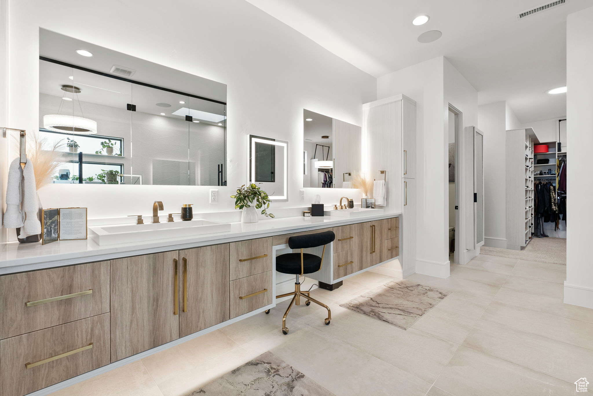 Bathroom with tile patterned flooring, vanity, and a shower