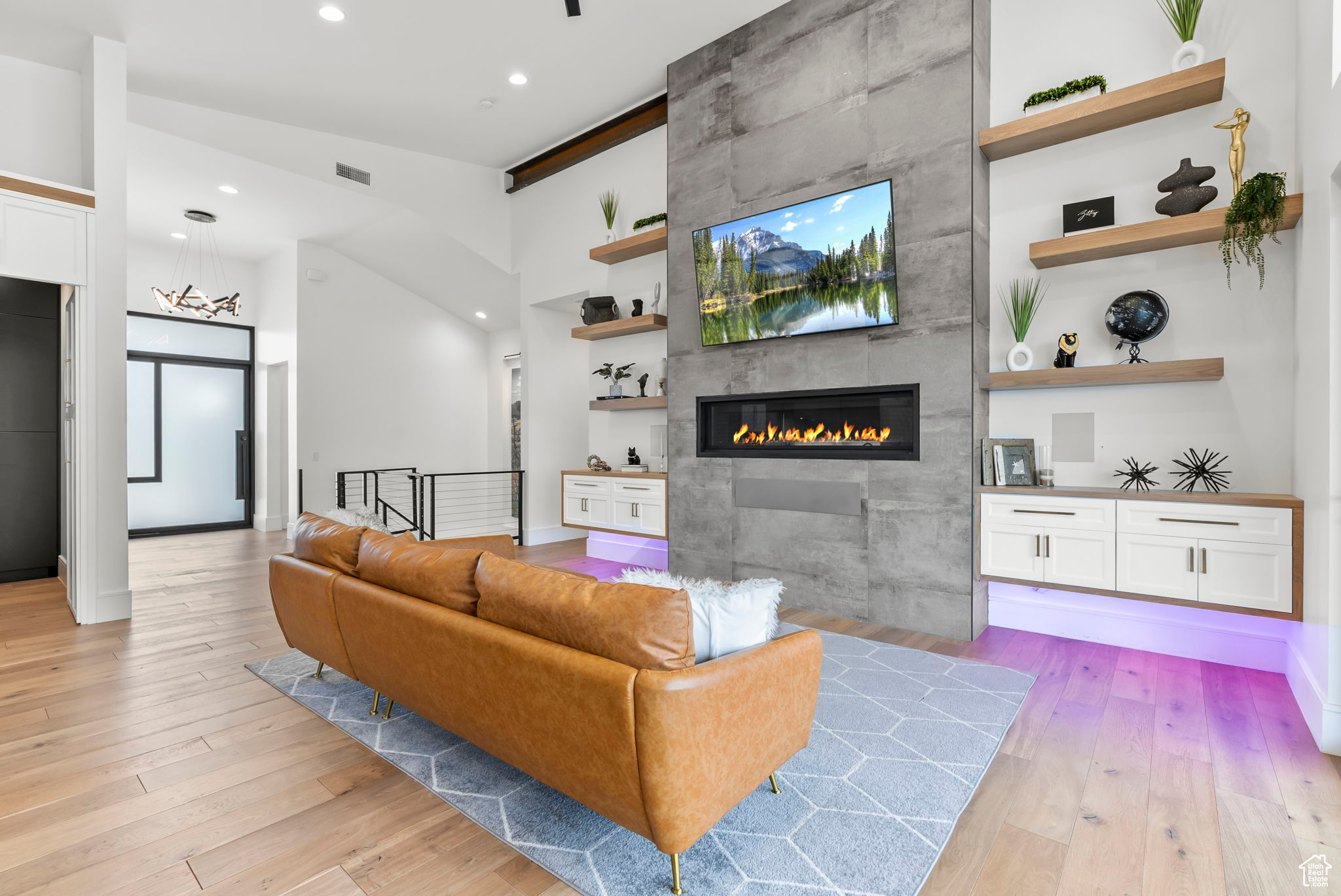 Living room with a fireplace and light hardwood / wood-style flooring