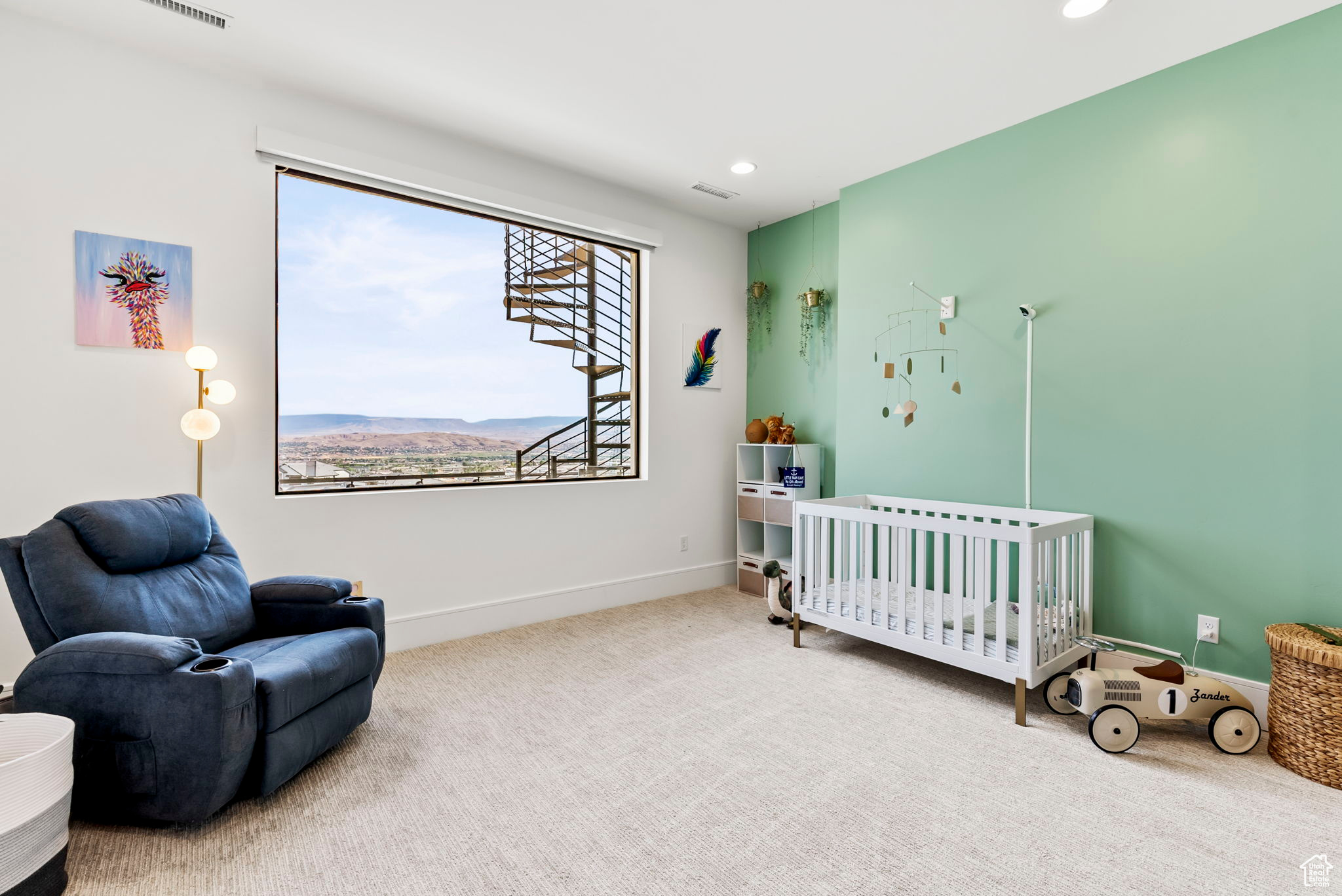 Carpeted bedroom featuring a mountain view and a nursery area