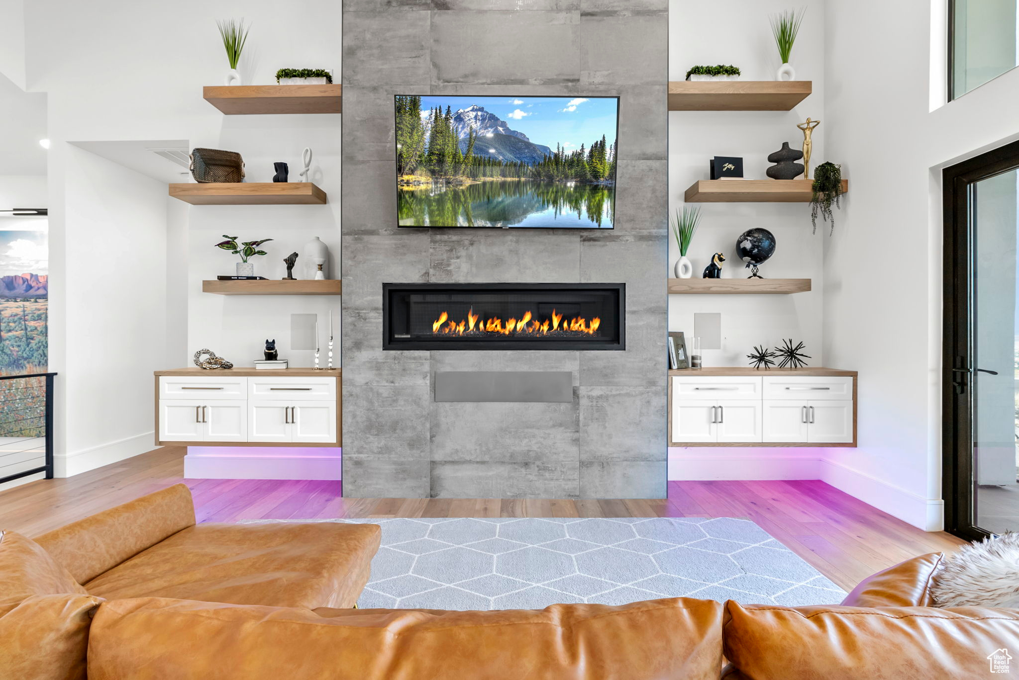 Bar with a fireplace, light hardwood / wood-style floors, and white cabinetry