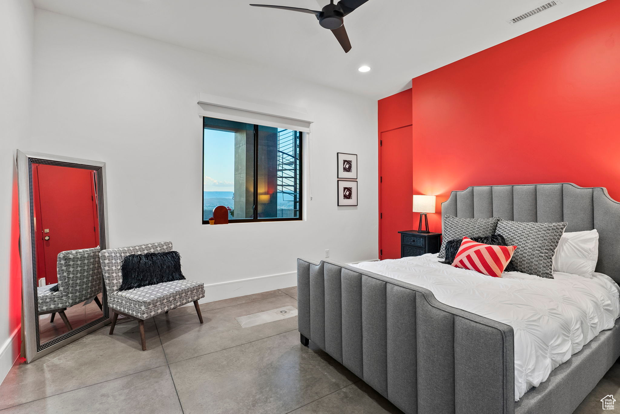 Bedroom with ceiling fan and concrete flooring