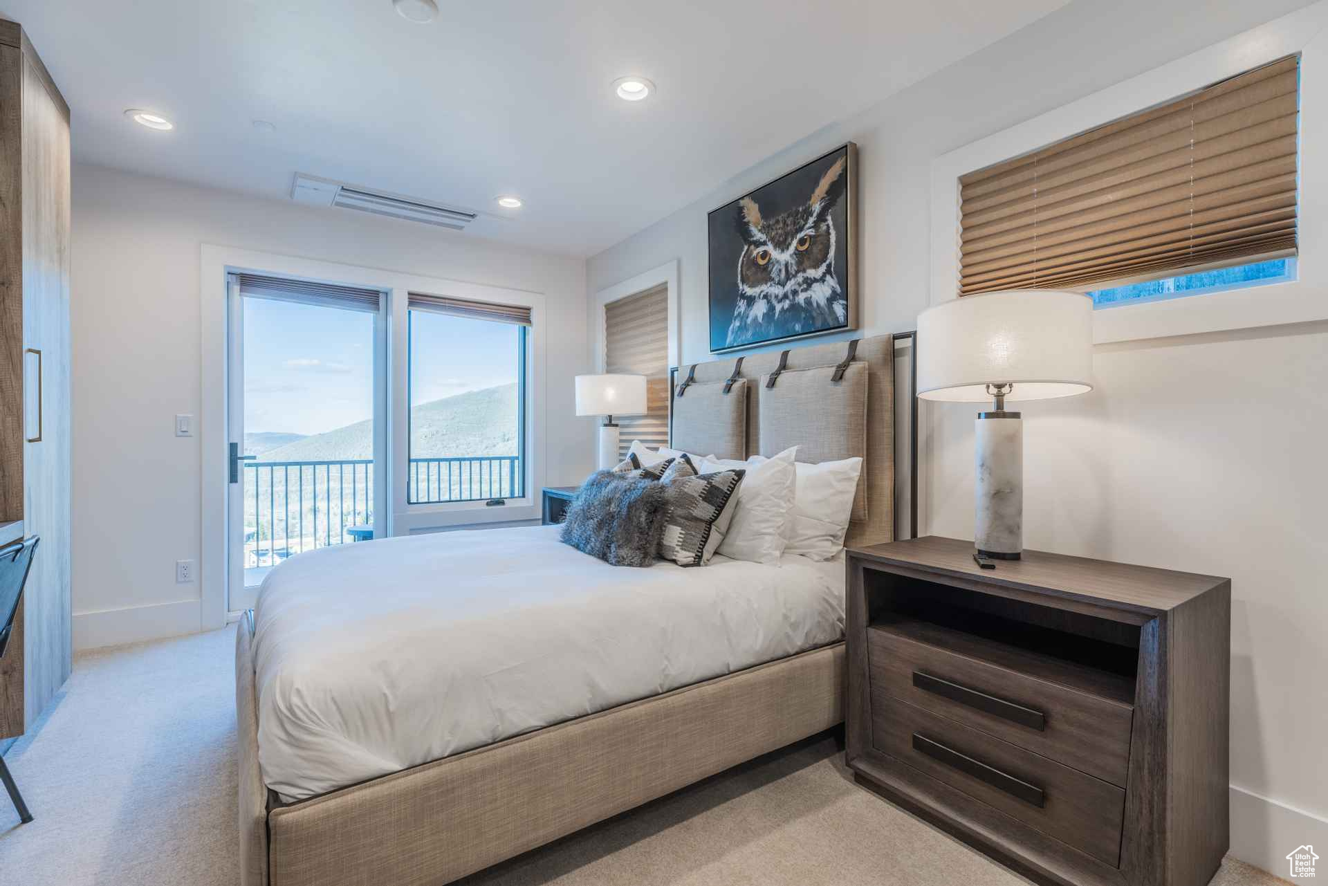 Bedroom featuring access to exterior, a mountain view, and light colored carpet