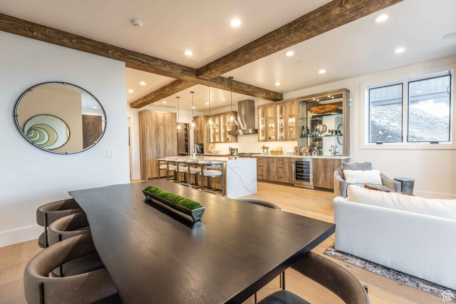 Dining area featuring beamed ceiling, light hardwood / wood-style flooring, and beverage cooler