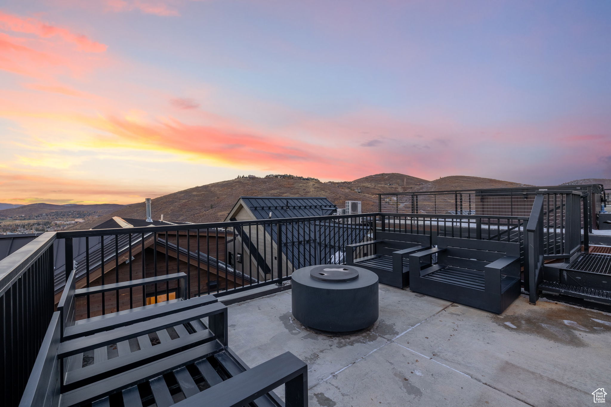 Patio terrace at dusk with a mountain view and an outdoor fire pit