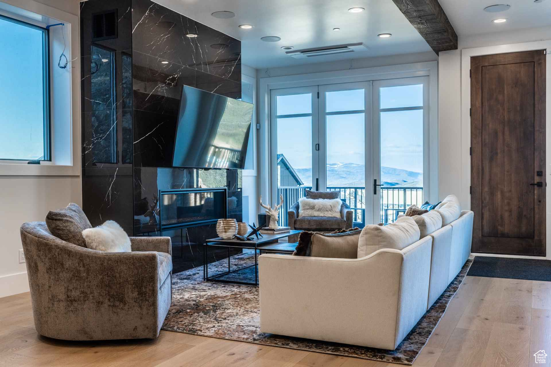 Living room featuring a wealth of natural light, hardwood / wood-style floors, and french doors