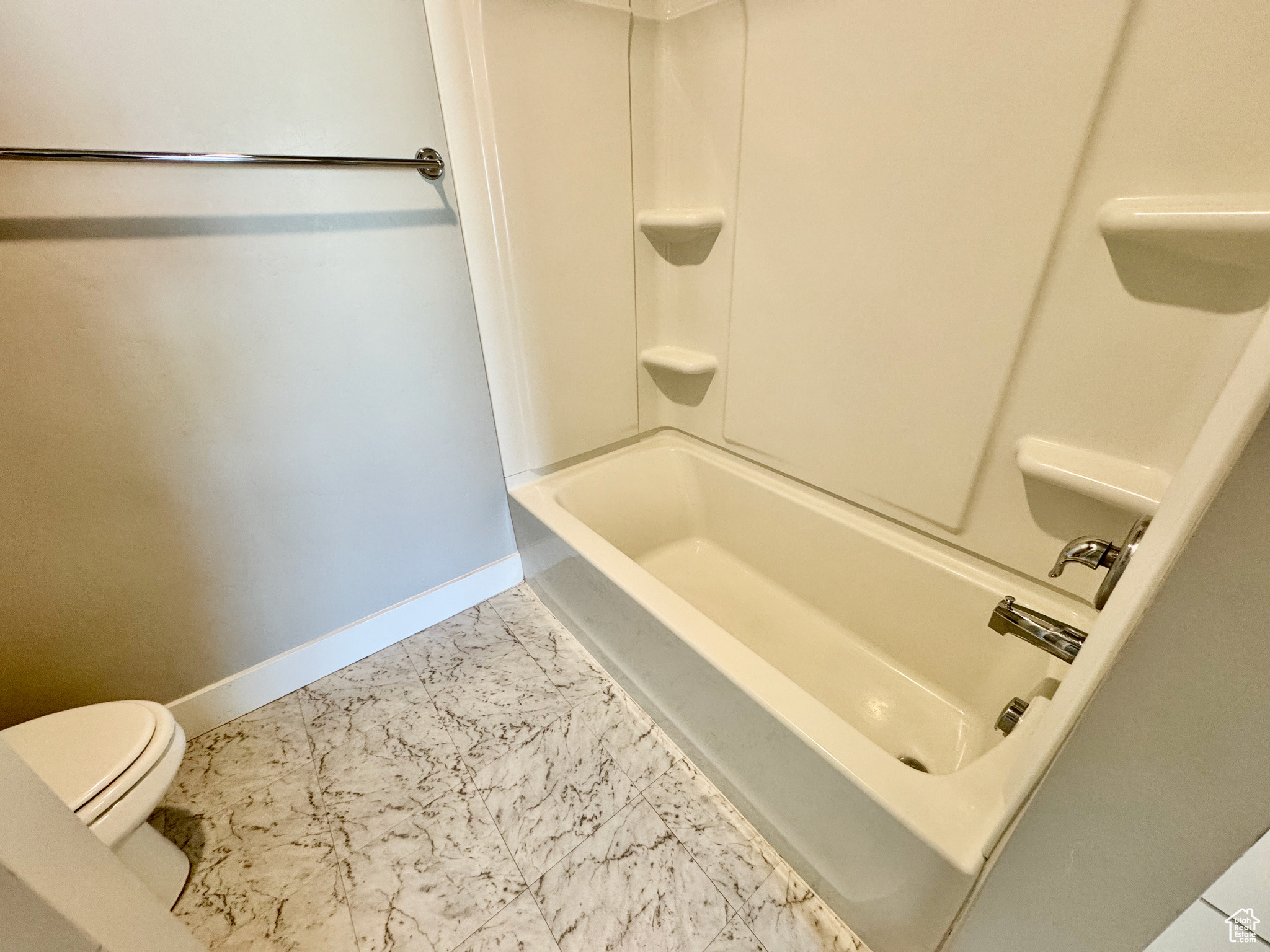 Bathroom with shower / bathing tub combination and toilet