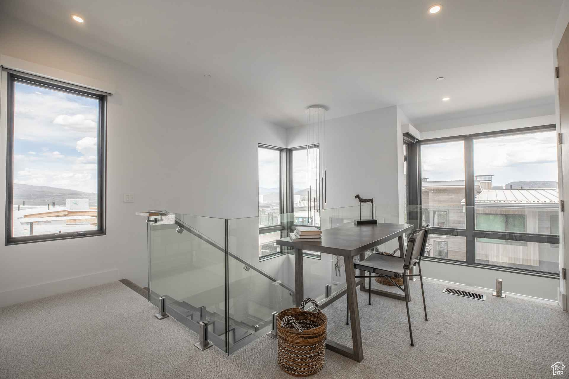 Carpeted dining room featuring a wealth of natural light