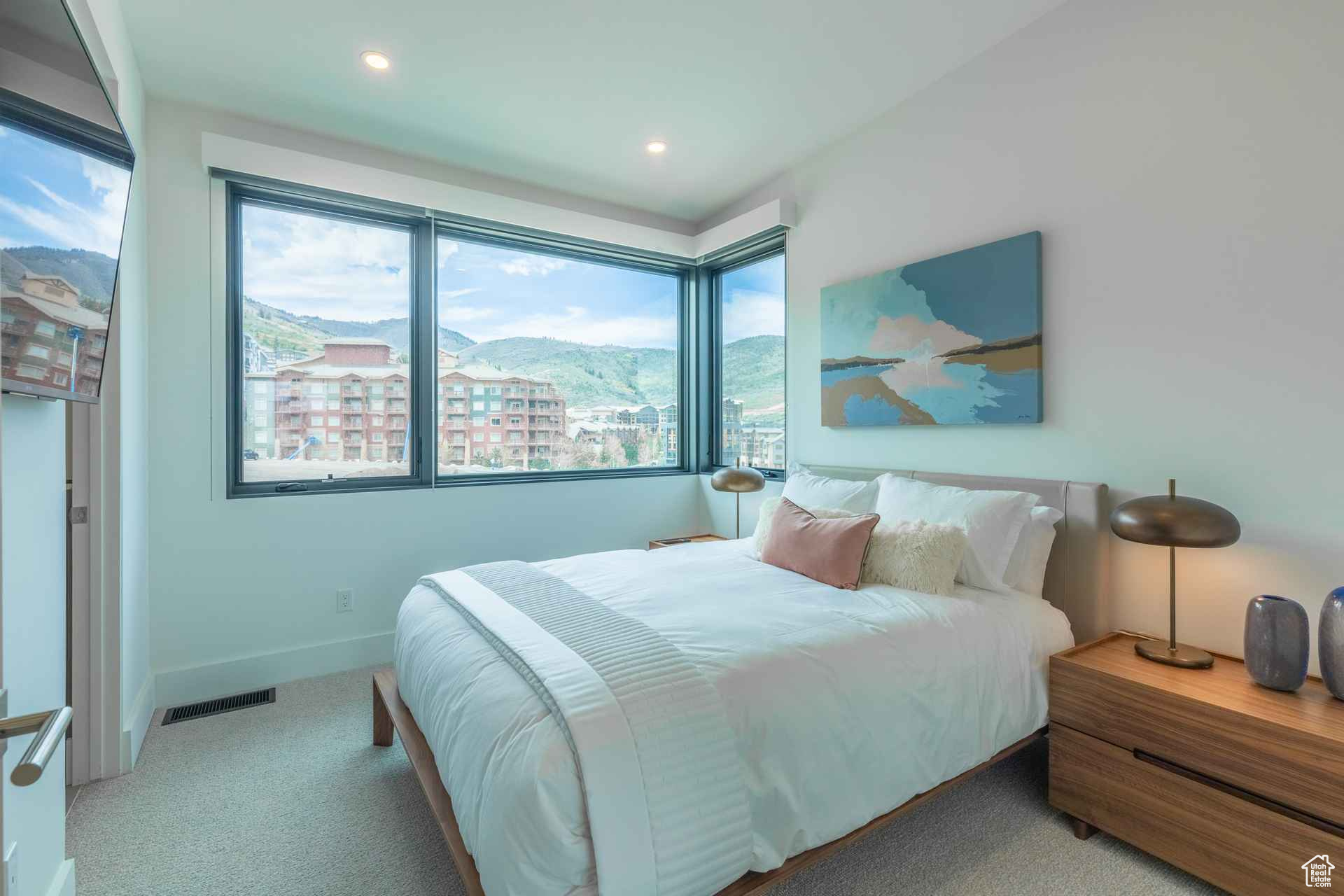 Carpeted bedroom with a mountain view