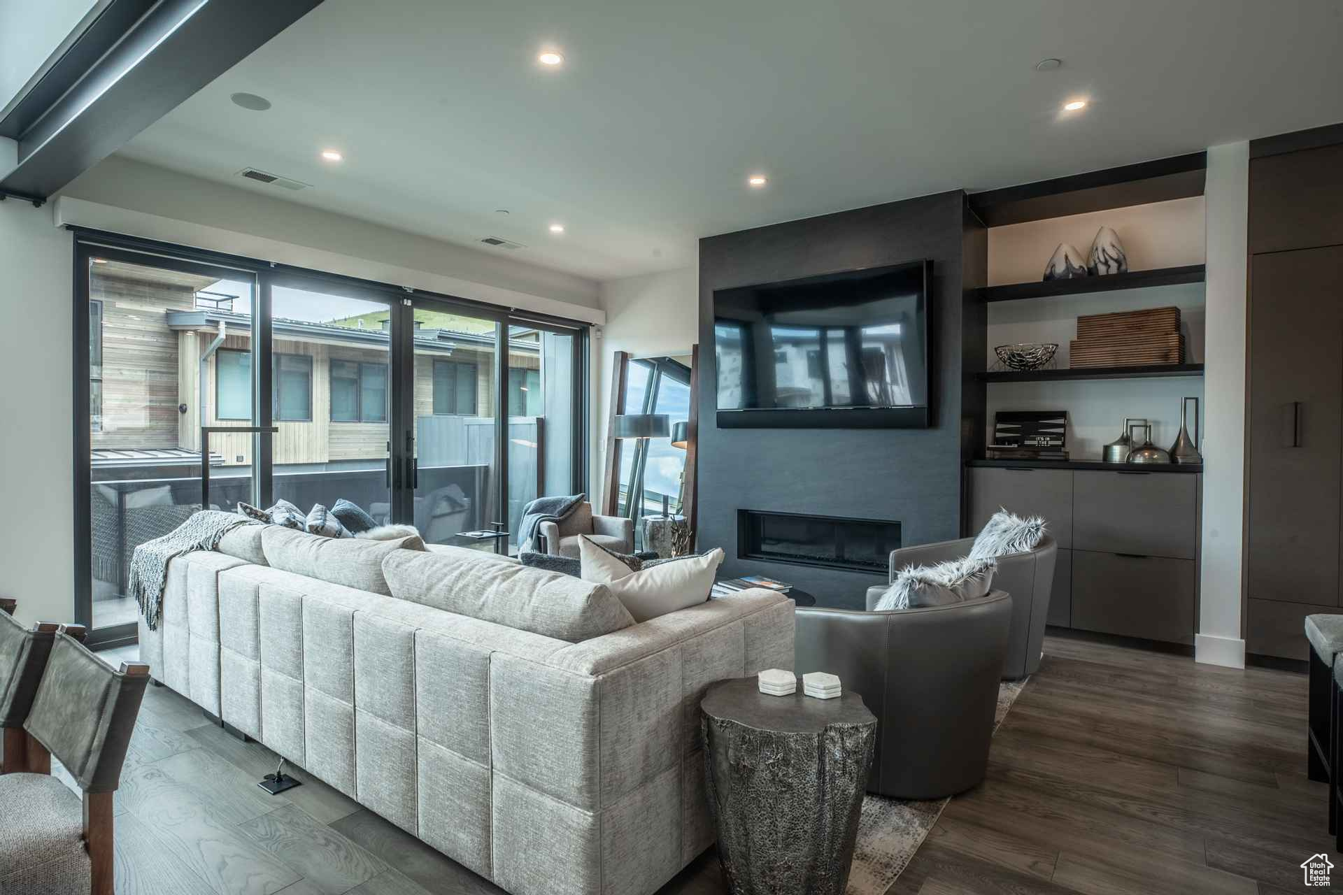 Living room featuring a fireplace and dark wood-type flooring