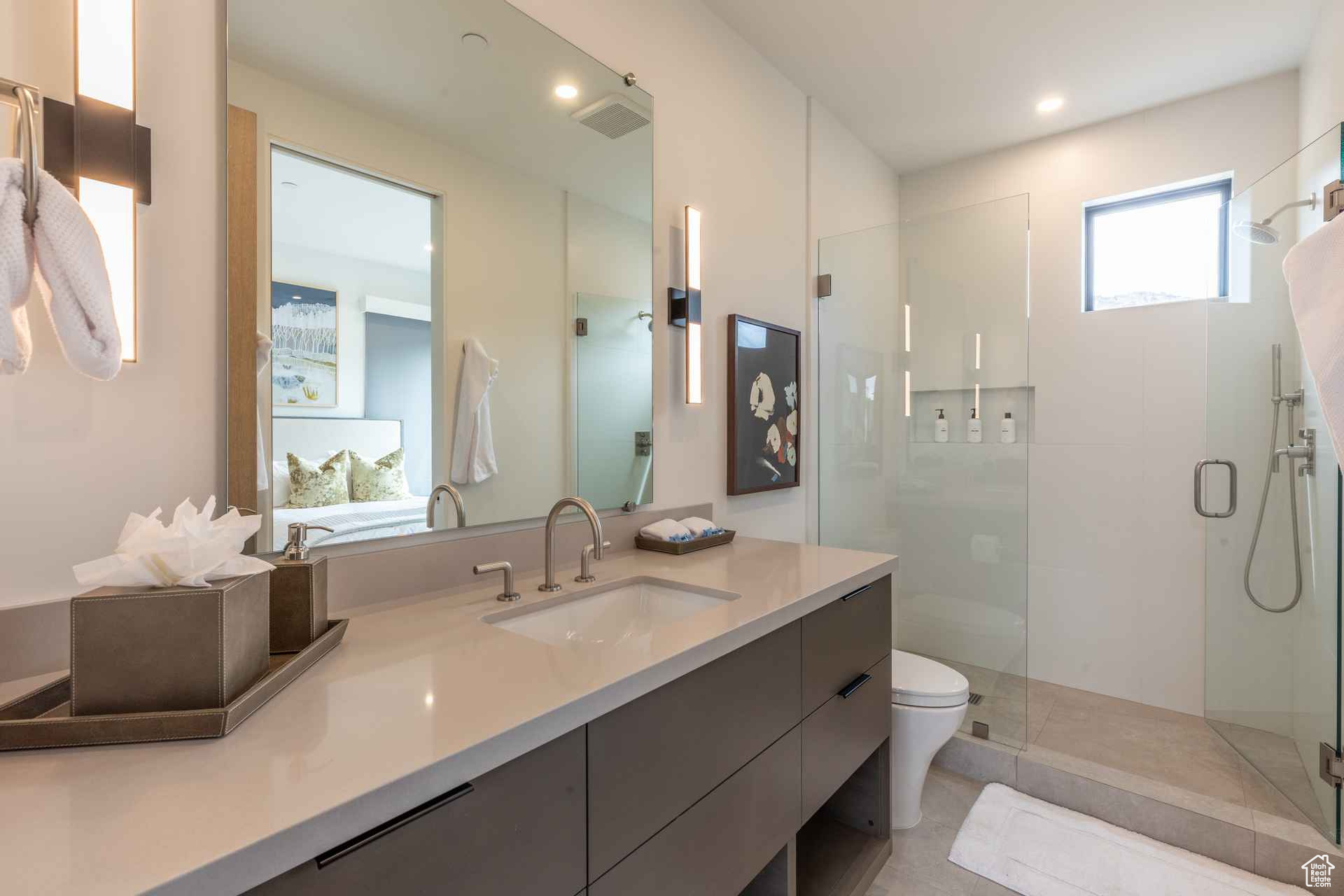Bathroom with vanity, toilet, and walk in shower