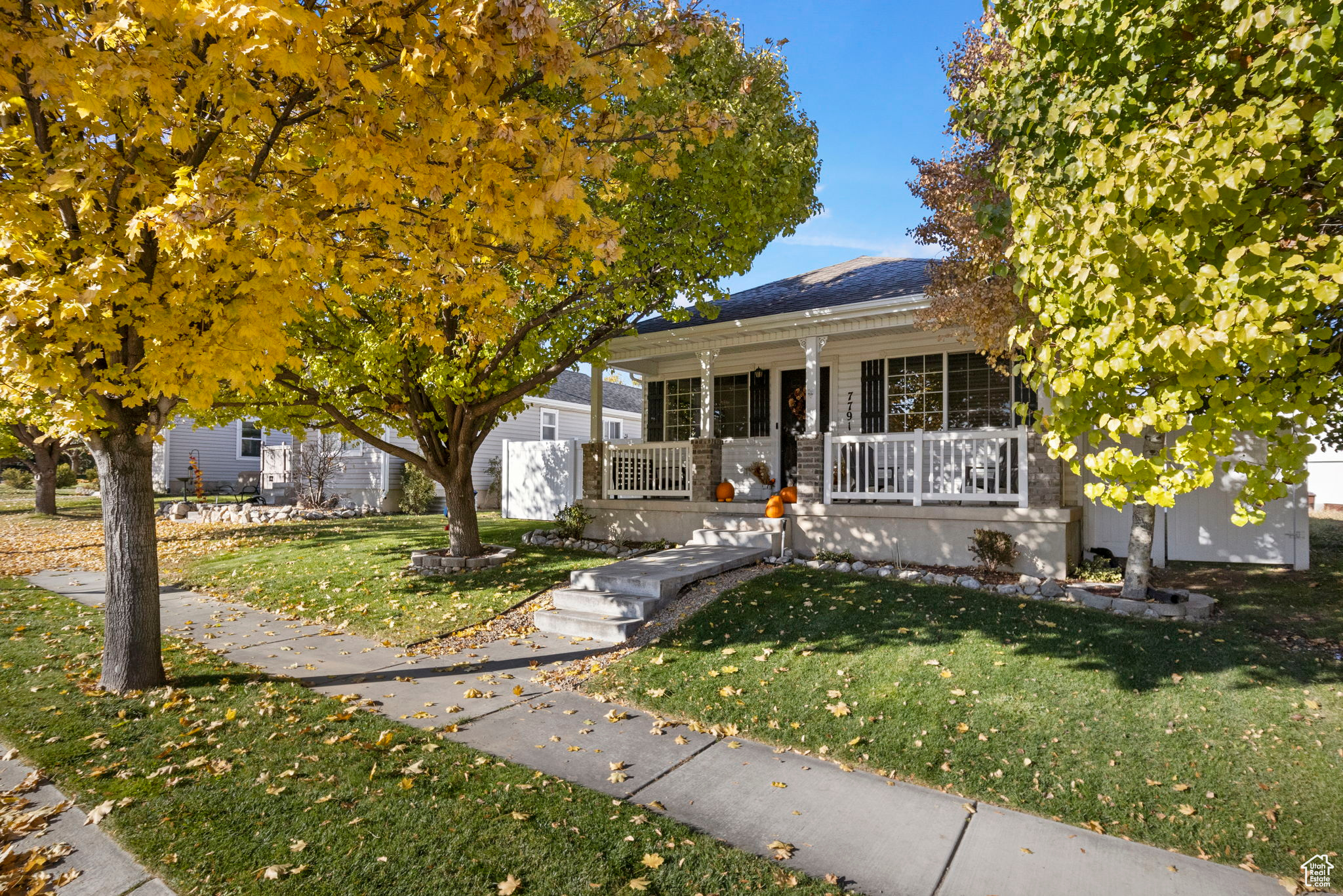 View of front of house with a porch and a front lawn