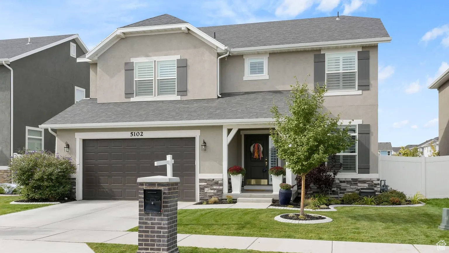 View of front of property featuring a front yard and a garage