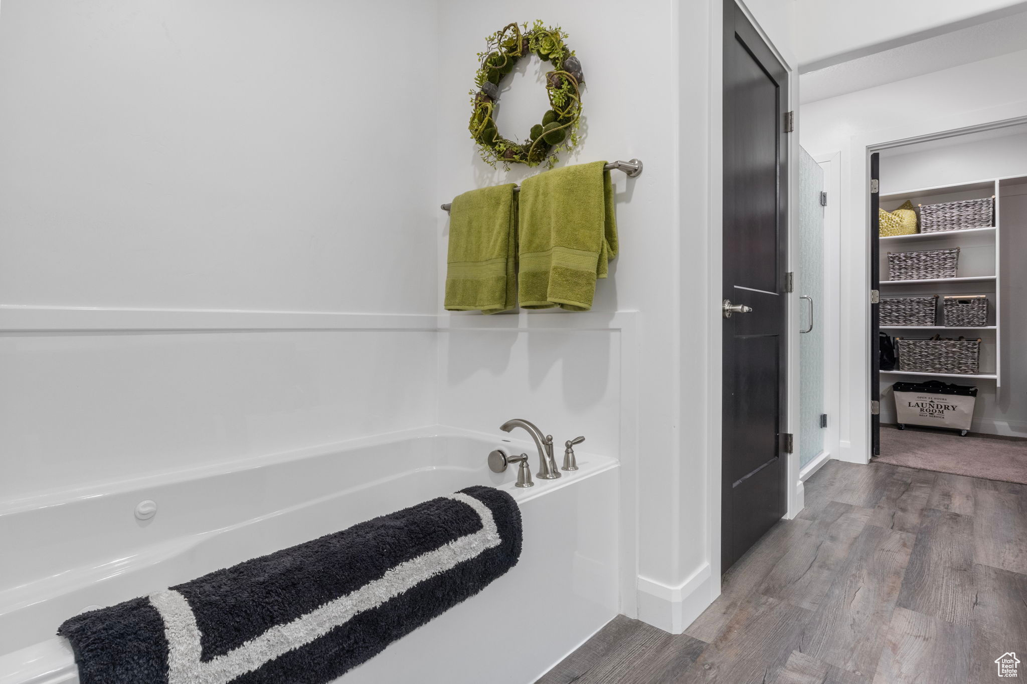 Bathroom featuring hardwood / wood-style flooring and a bathtub
