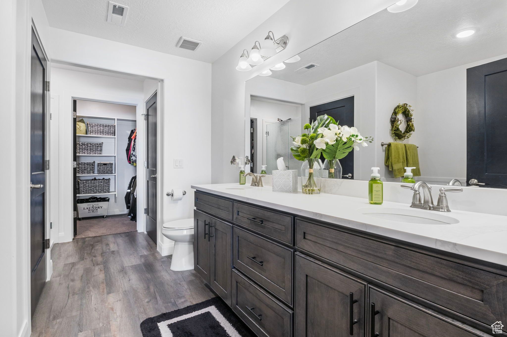 Bathroom with a shower, wood-type flooring, vanity, and toilet