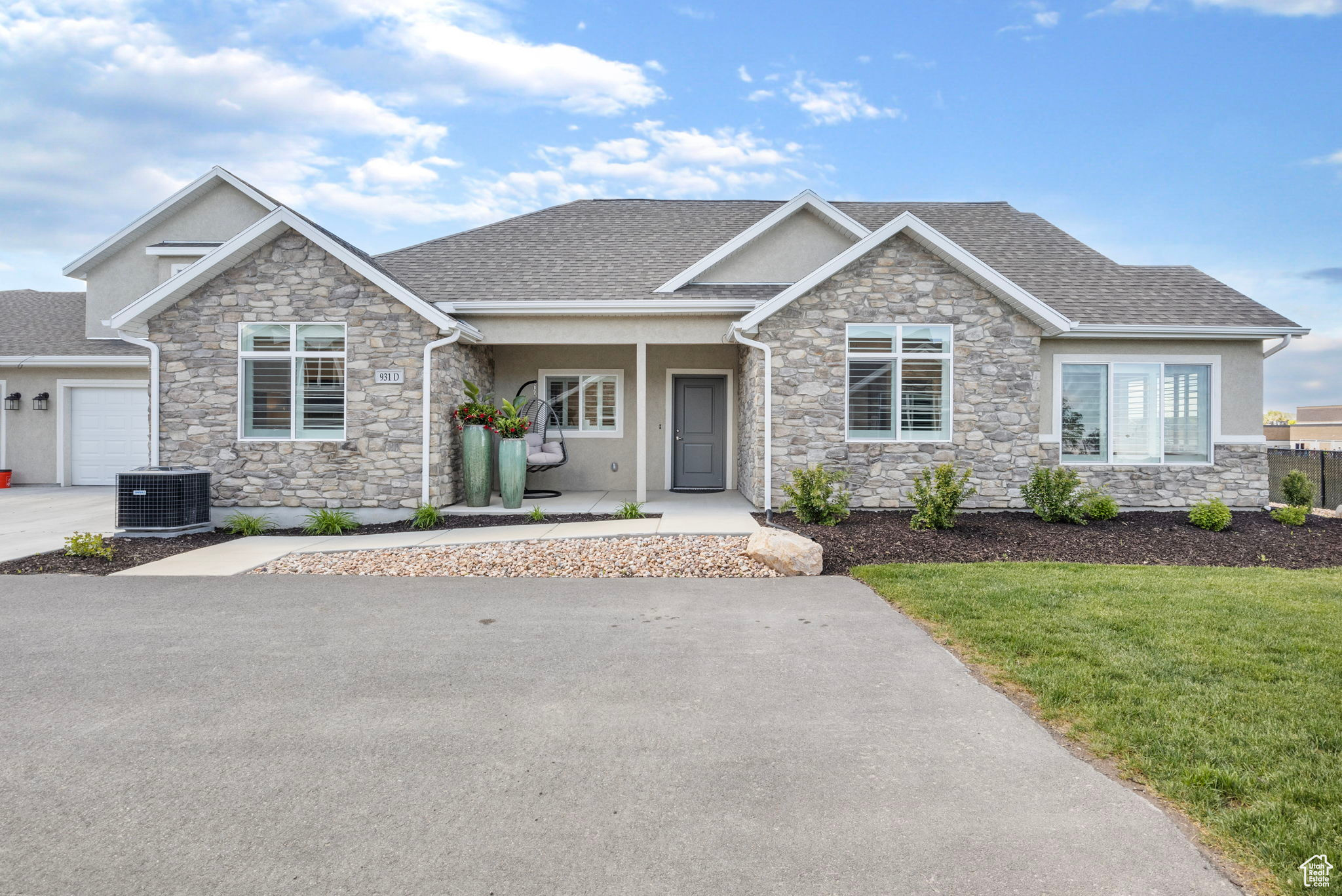 Craftsman house featuring a porch, a garage, central air condition unit, and a front lawn