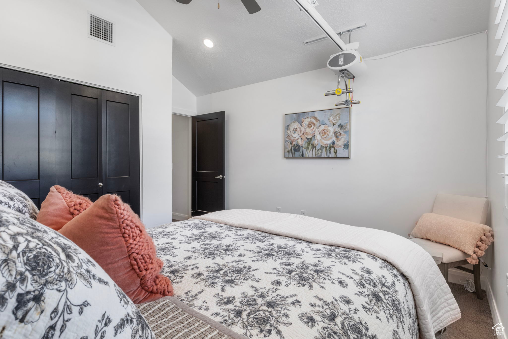 Bedroom with carpet flooring, ceiling fan, a closet, and high vaulted ceiling